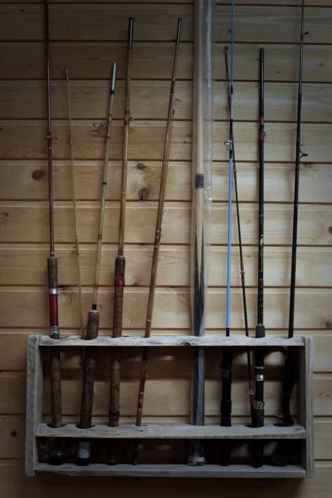 Fishing Rods standing in a rod holder at a wall