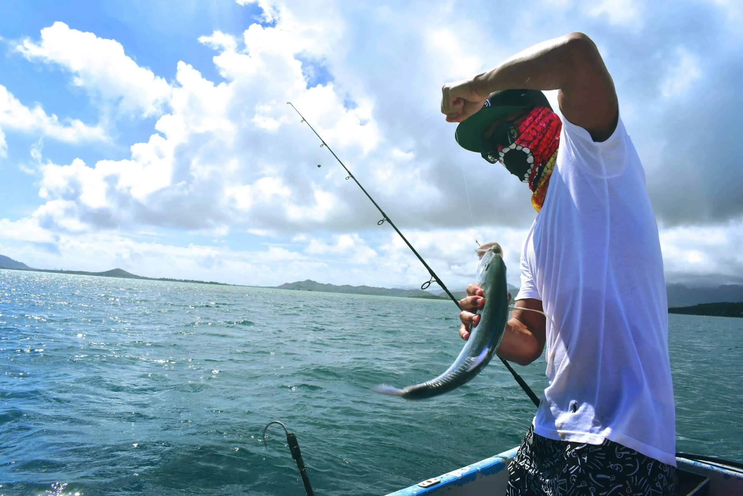 Man wearing best Fishing Face Mask catching a Fish