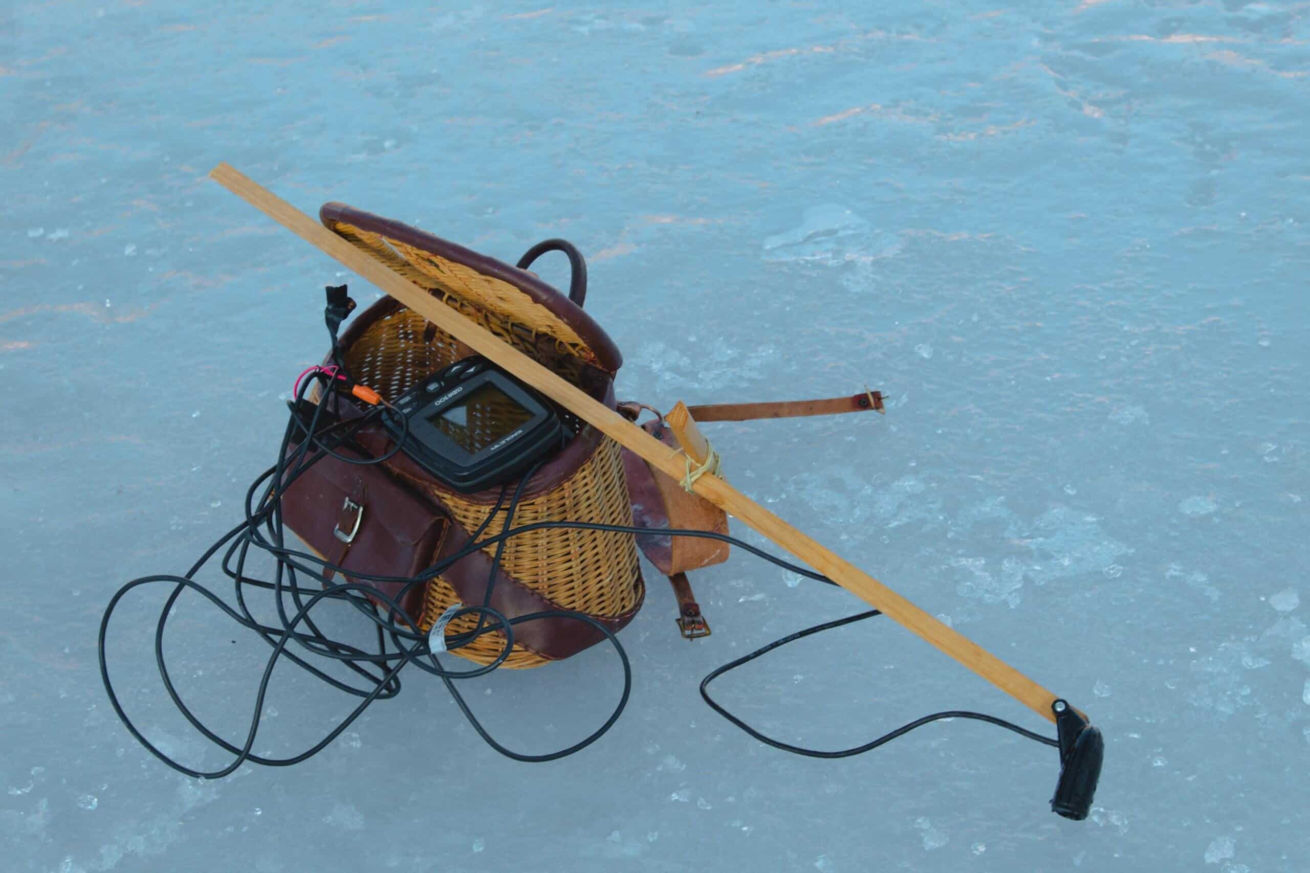 Brown bag on frozen lake with equipment and best ice fishing flasher