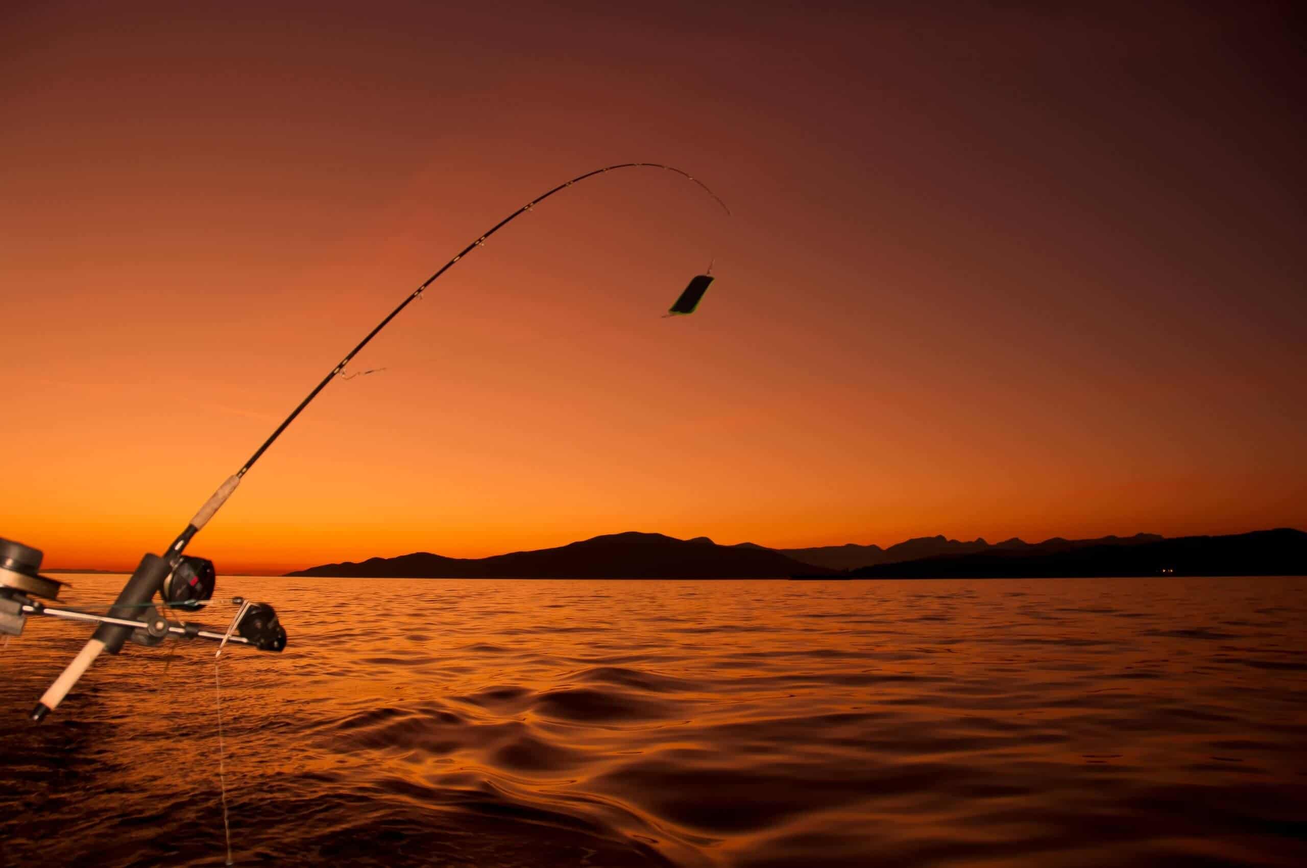 ocean fishing from boat at golden hour with a fishing rod in one of the best crappie rod holders