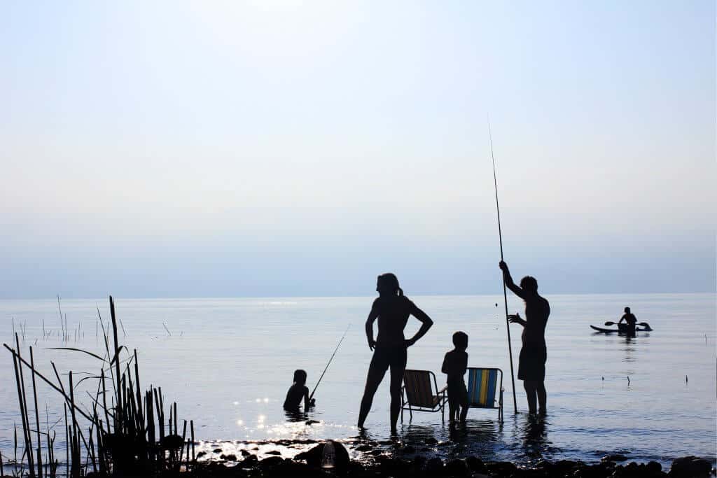 Family at ocean, fishing with one of the best traveling fishing rods