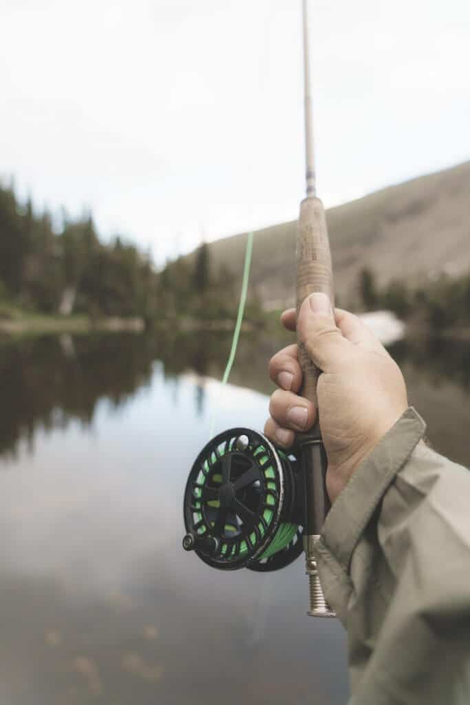 man holding one of the best ultralight fishing rod fishing at lake