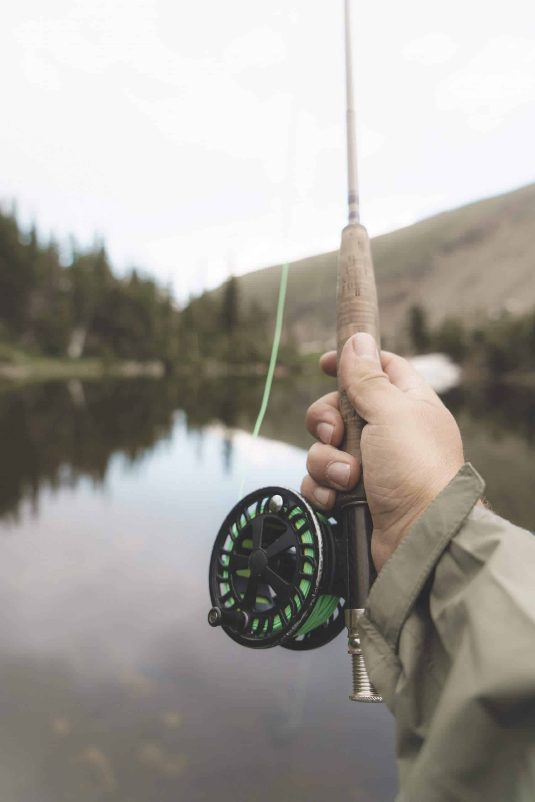 man holding one of the best ultralight fishing rod fishing at lake