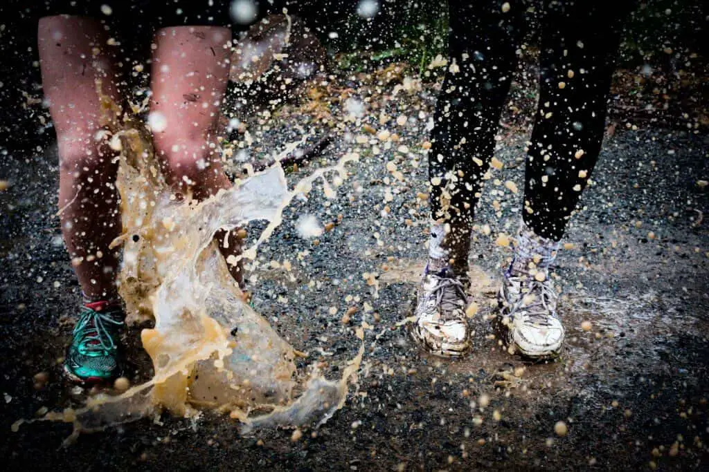 two women running splashing water