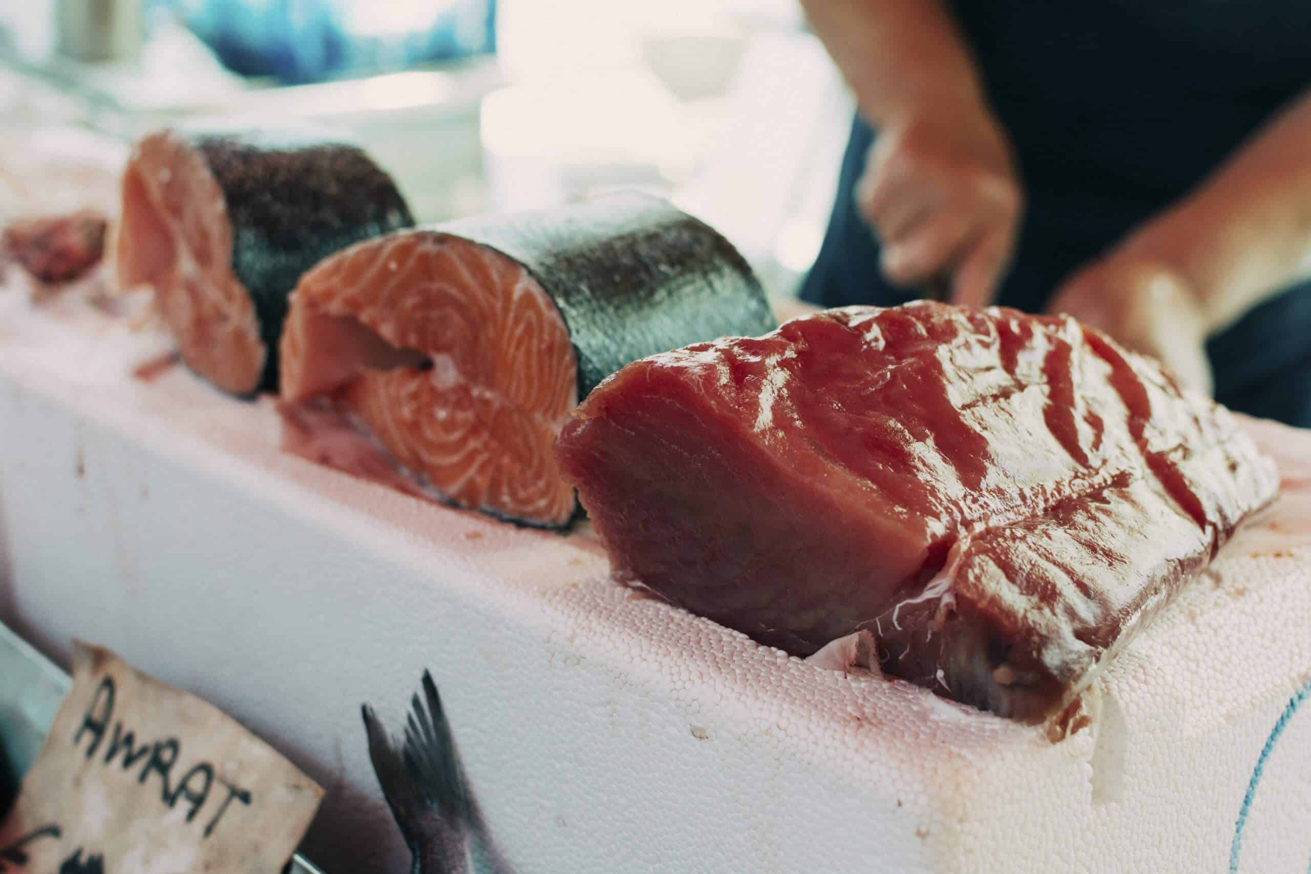 Man cutting salmon fillet with one of the best electric fillet knives