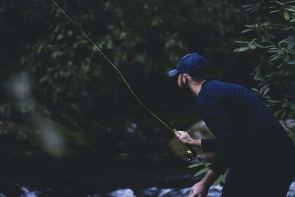 Blurry Photo of man fly fishing