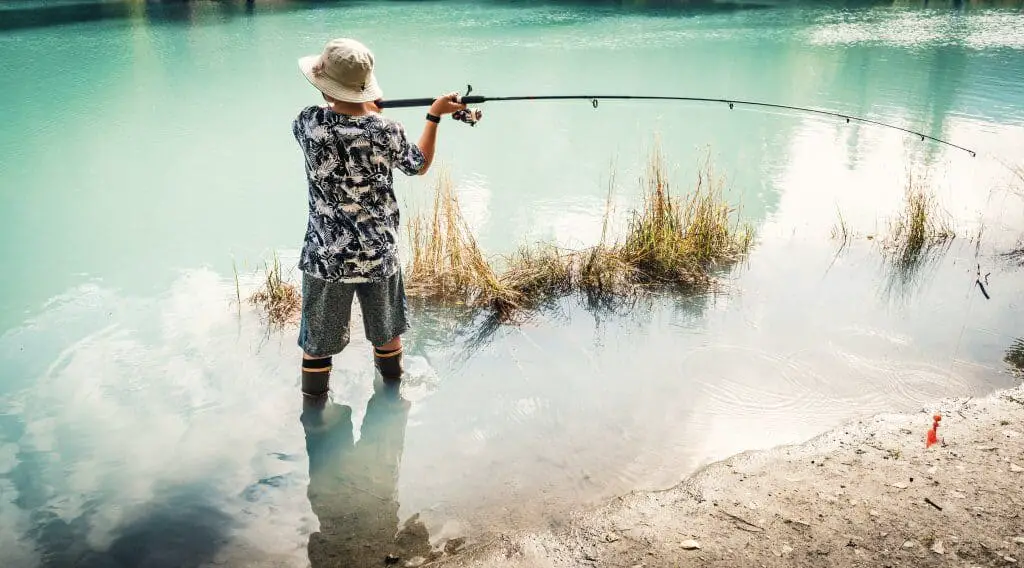 Young man holding a fly fishing rod