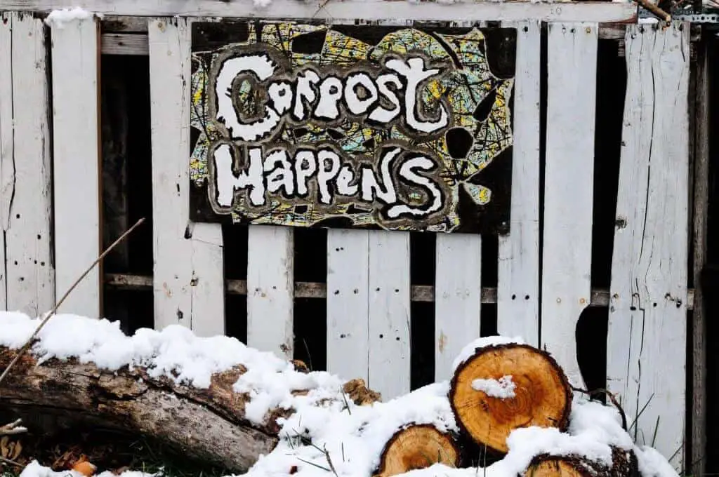 Can fishing worms be used for composting? Sign saying "compost happens" hanging on a fence in the winter