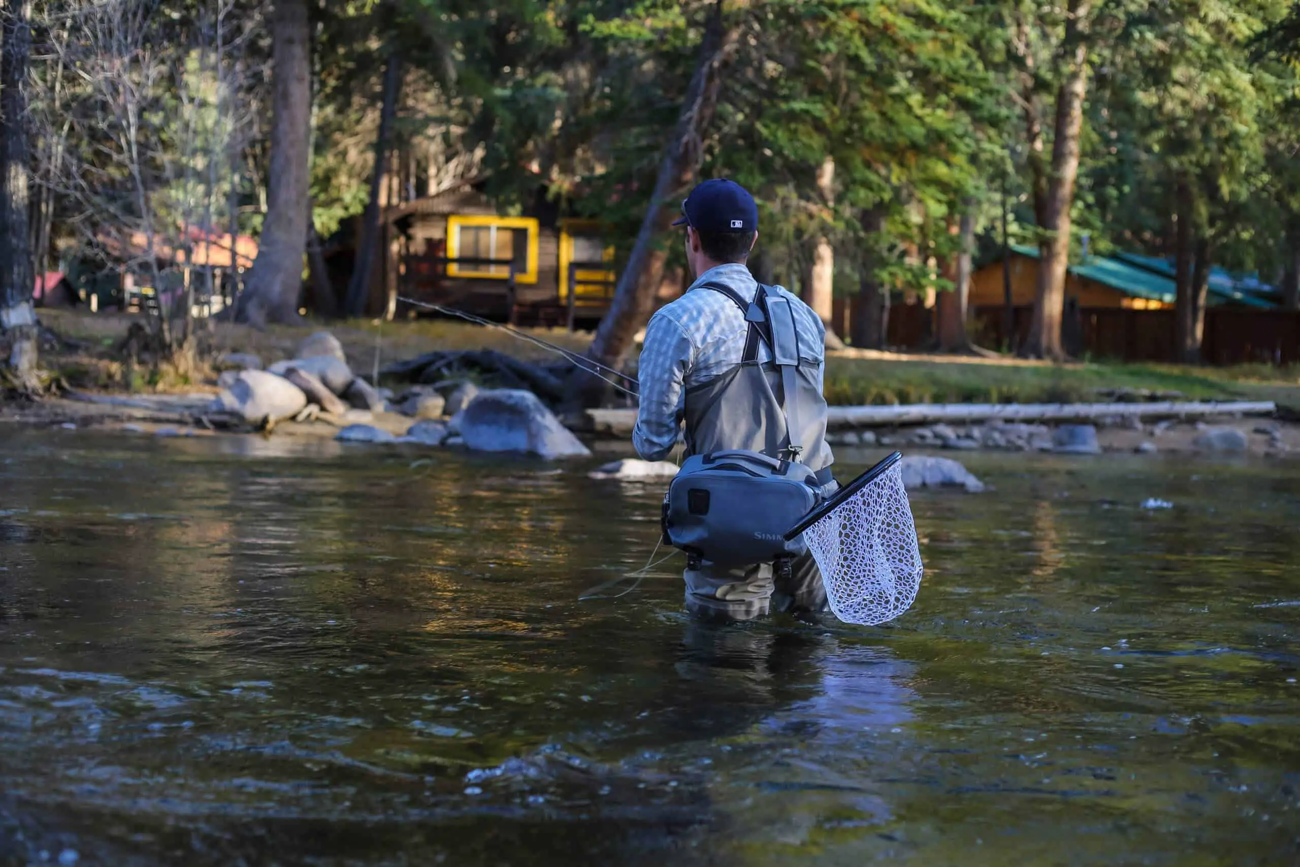 Man wearing some of the best fly-fishing waders for the money fishing in a stream