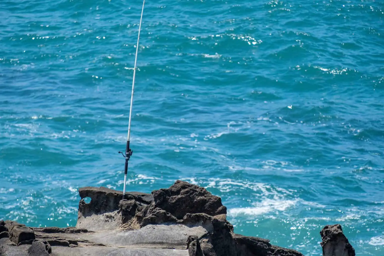 One of the best surf casting rods on a cliff in front of the ocean