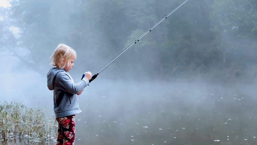 The future of fishing: young girl learning how to fish