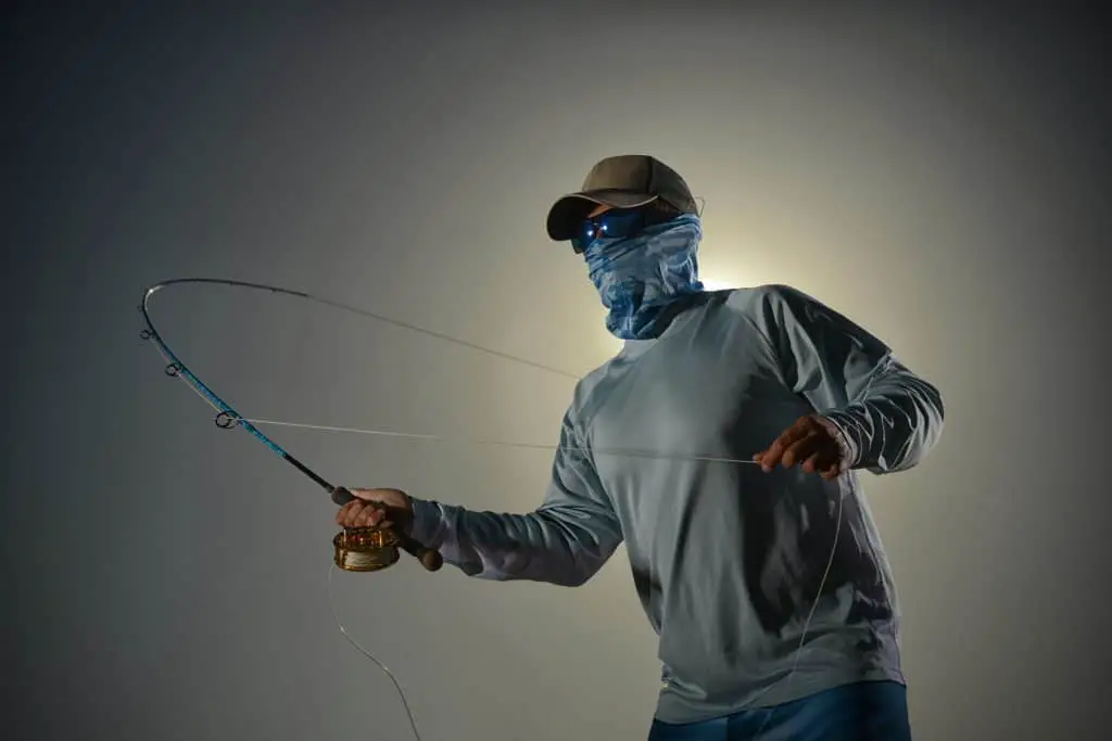 man wearing one of the best best face shield for fishing