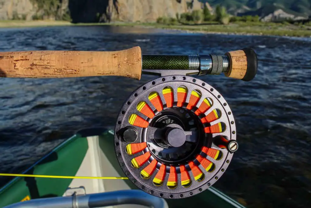 Close up of a fly fishing rod, reel and fly line, in the late evening sun