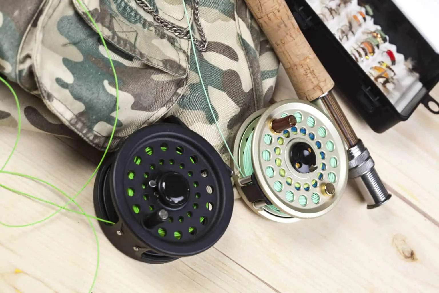 Mooching Reel vs Fly Reel - What are the differences. Fly reels on a wooden surface