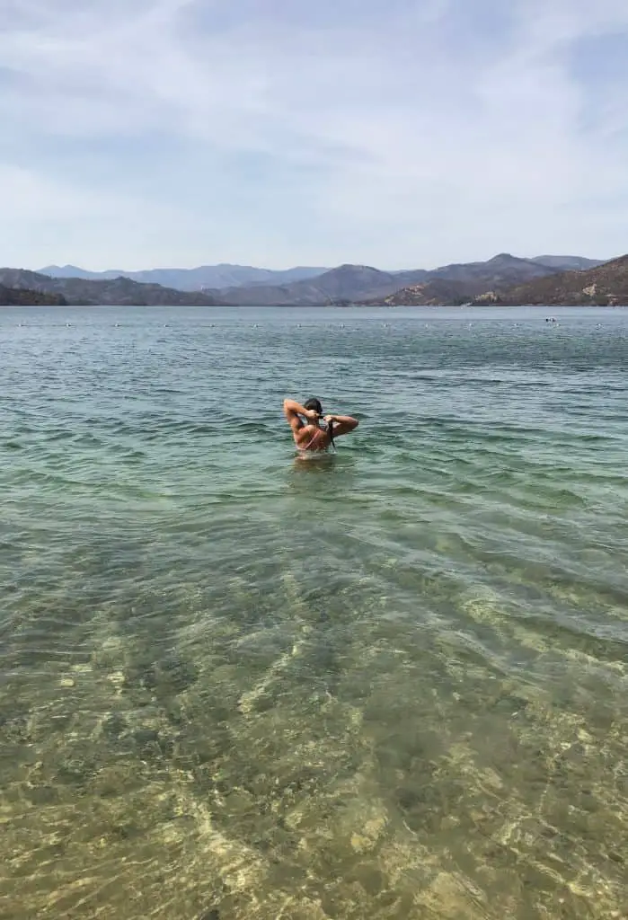 A woman walking into the water in Redding