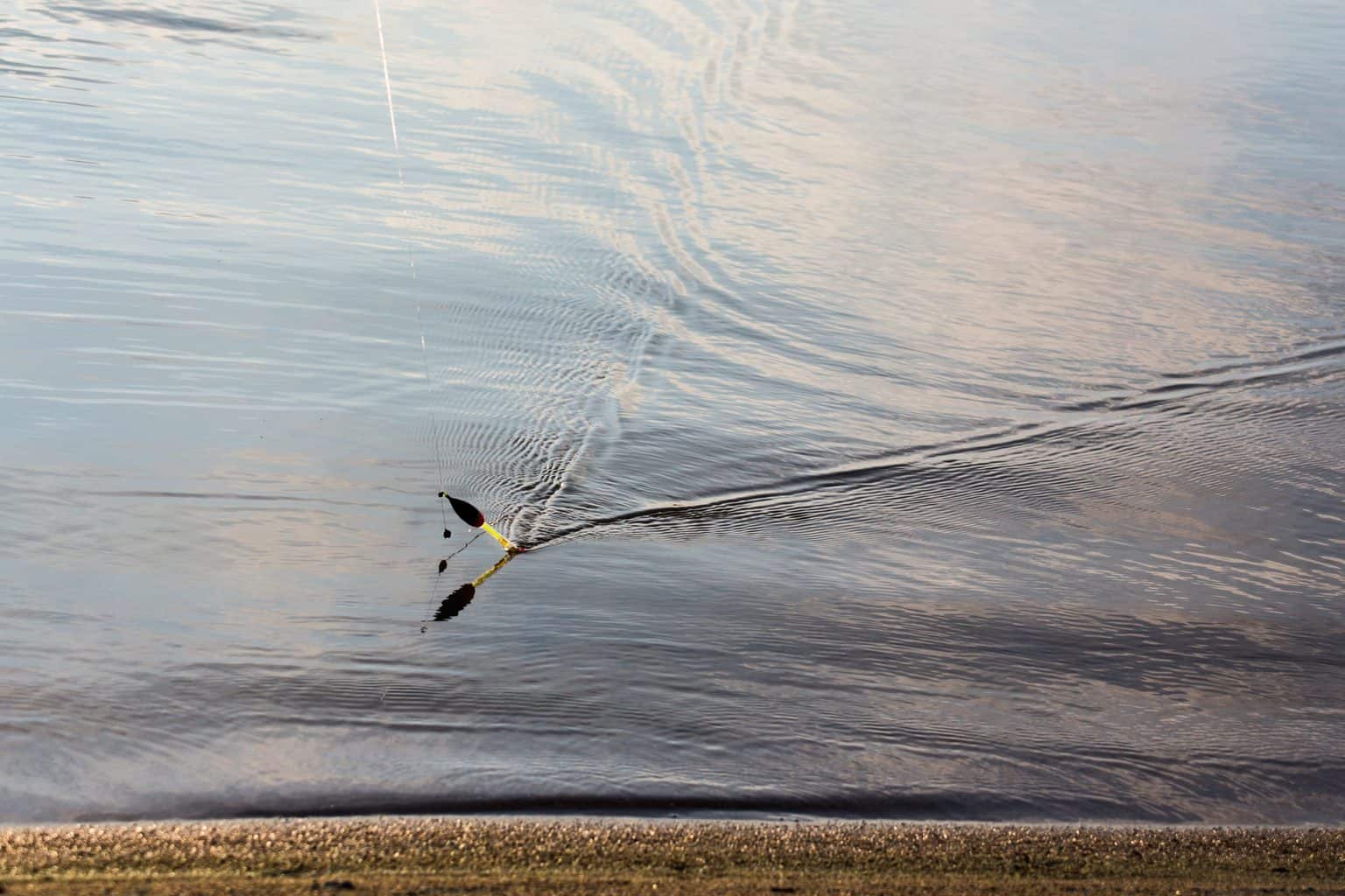 A fishing float in cristal water - check out our float fishing tips for beginners