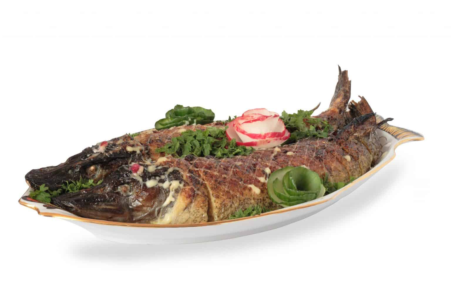 baked pike fish isolated and stuffed on a plate. Can you eat pike?
