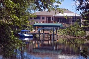What are Common Types of Fish in Florida Canals? a house and boat next to the canals