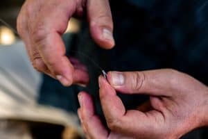 a man trying out How to Use a Fly Tying Kit